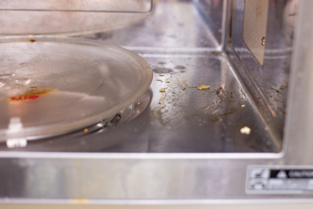 Dirty microwave interior before steam cleaning