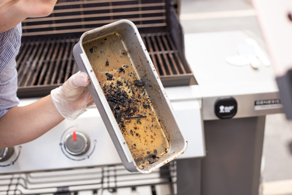 The grill grease is removed and dirty. 