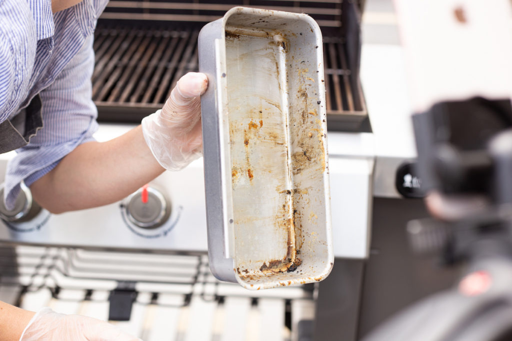 The grill grease tray is almost clean. 