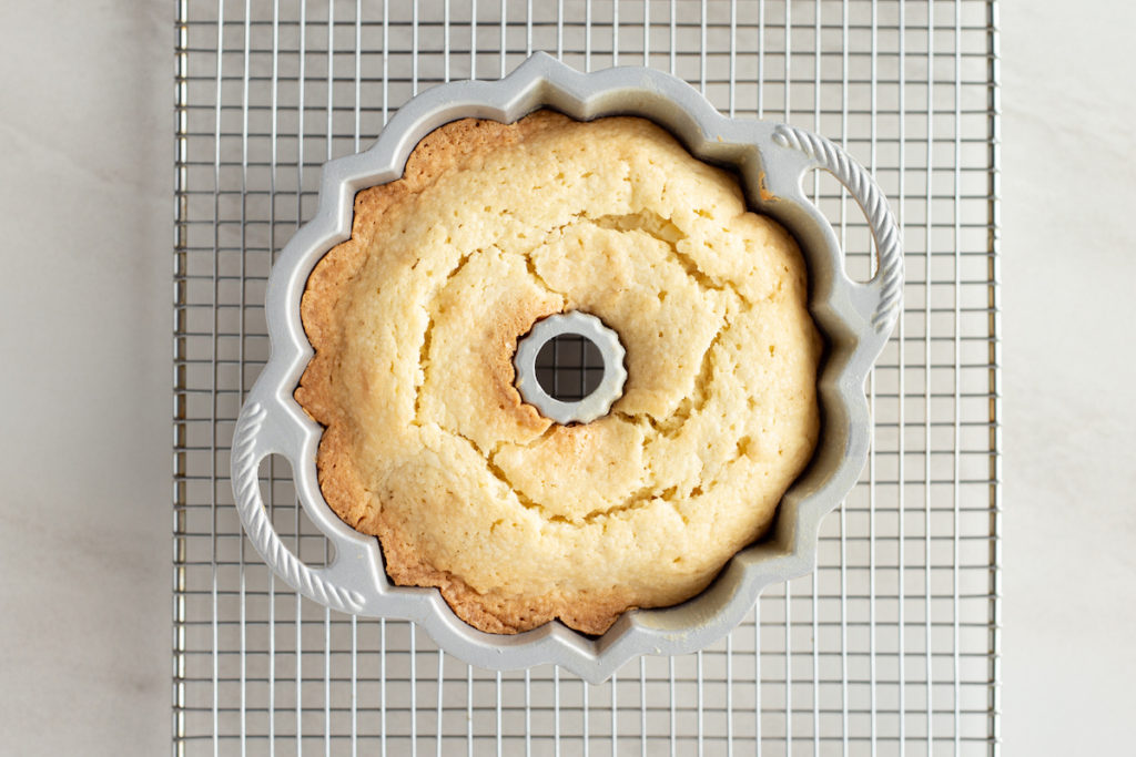 A bundt cake is still in the pan, just removed from the oven
