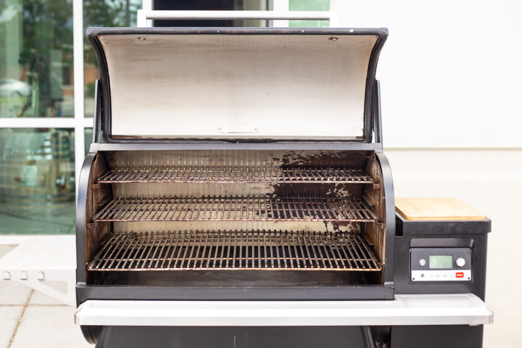 The pellet grill lid is open and the interior is clean. 