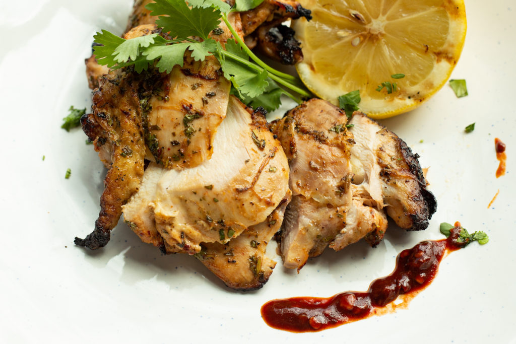 The cooked chicken thighs are staged on a plate and ready to eat. 