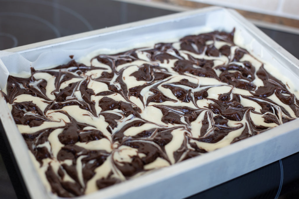 A tray of double chocolate cream cheese brownies are ready to go into the oven.