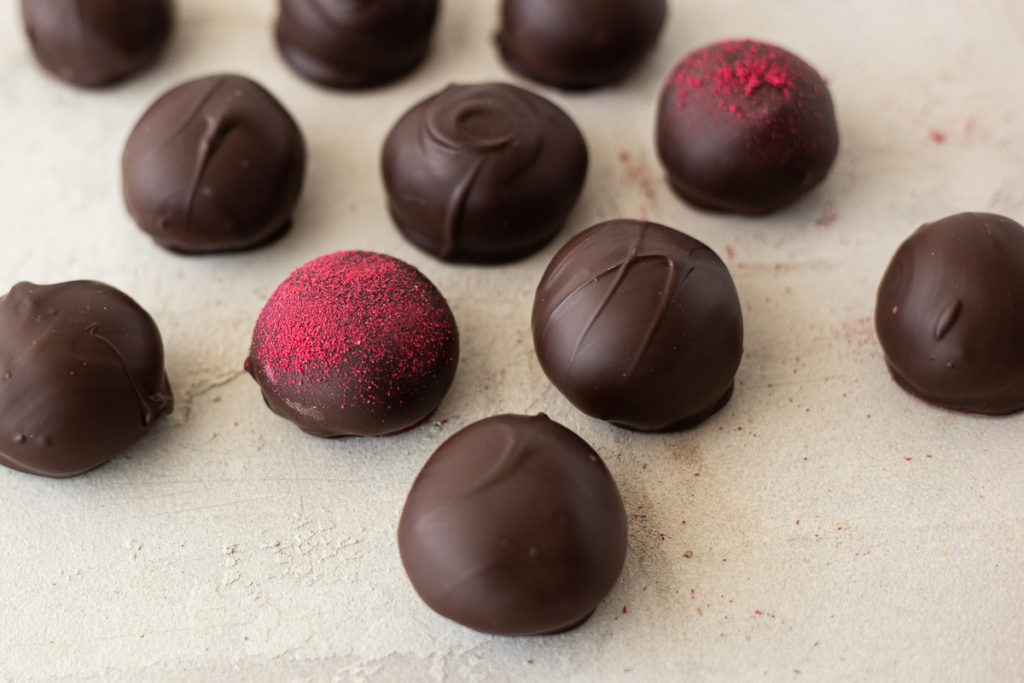 Buttercream centers dipped in chocolate and dusted with raspberry powder