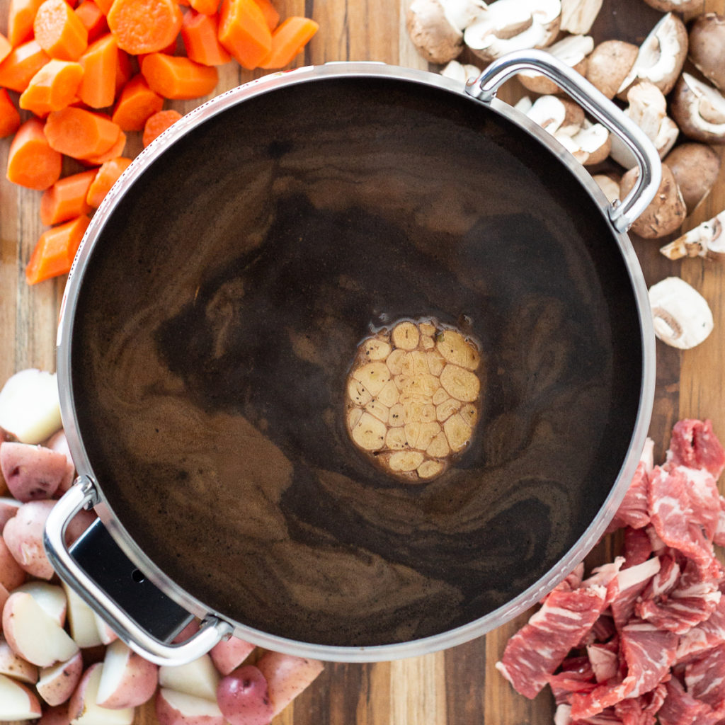 broth fondue with a garlic bulb