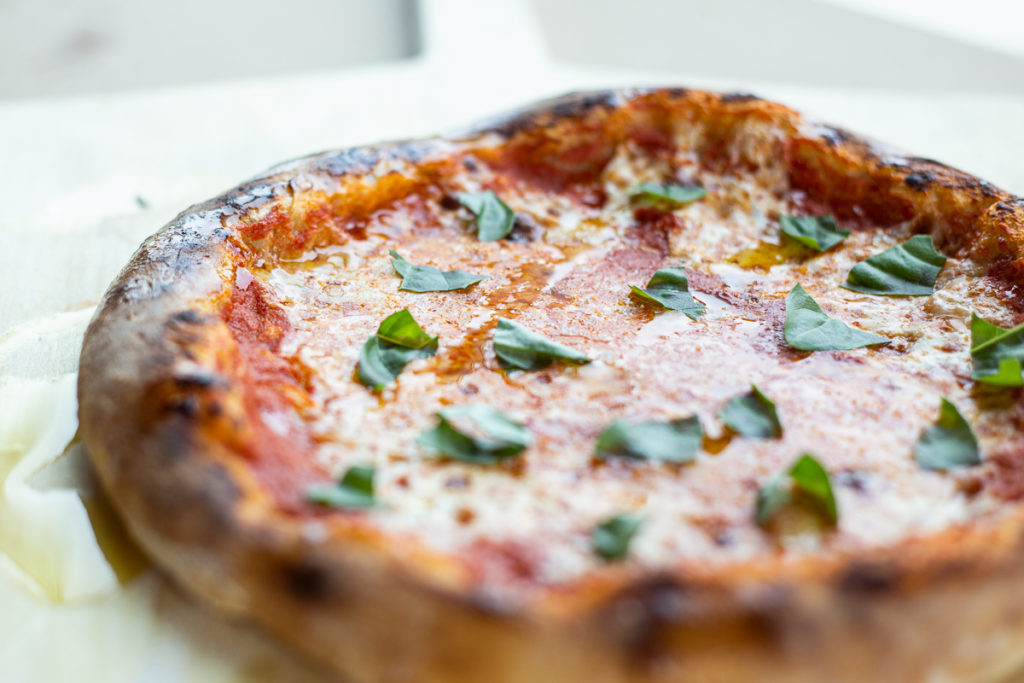 Homemade Neapolitan pizza topped with basil 