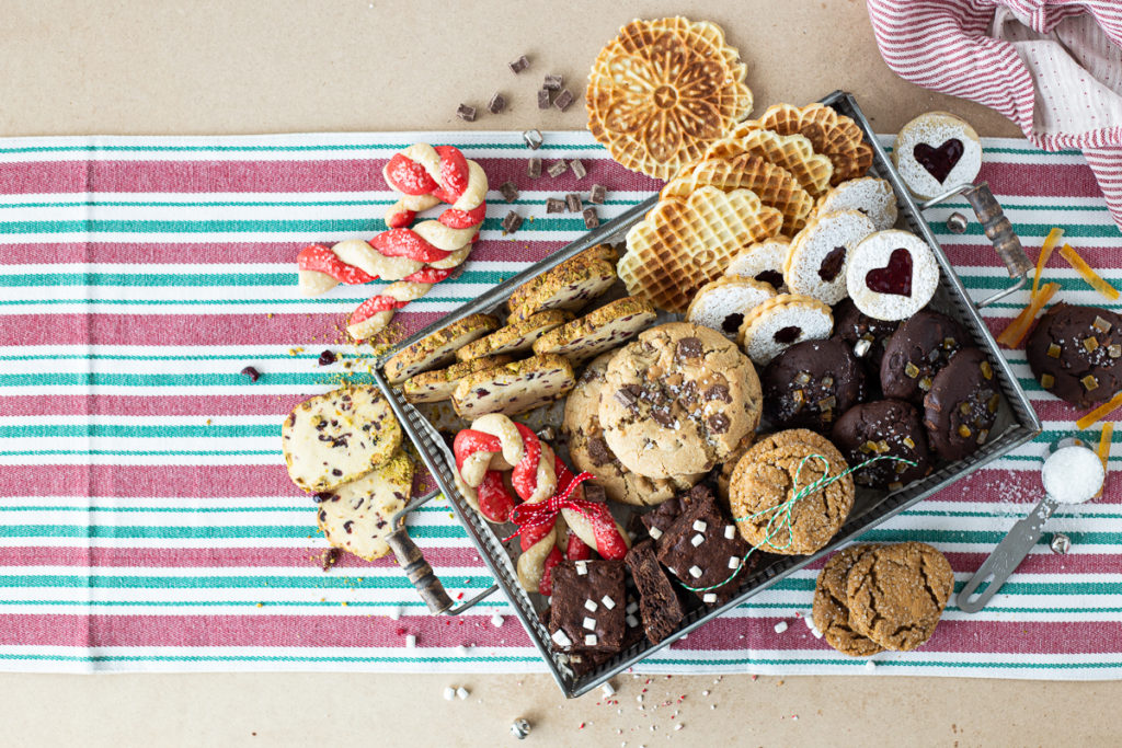 Assorted box of cookies including linzer cookies. 