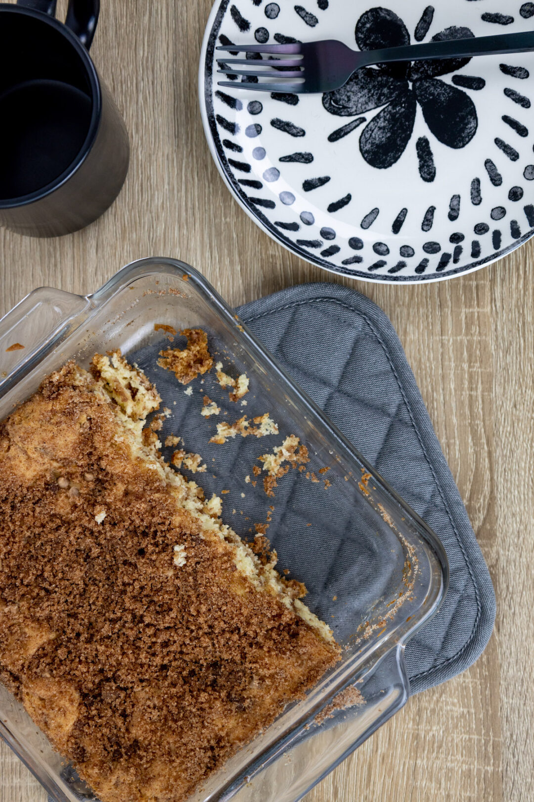 Square pan on cinnamon chip coffee cake positioned next to a plate