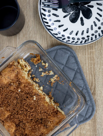 Square pan on cinnamon chip coffee cake positioned next to a plate