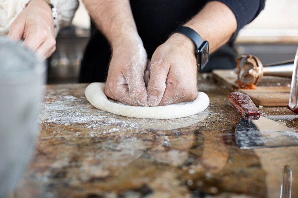 shaping pizza dough