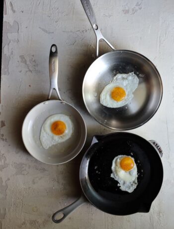 fried sunny side up eggs in three different frying pans