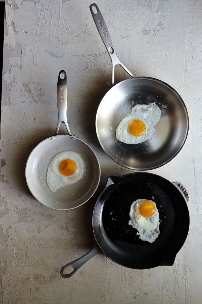 fried sunny side up eggs in three different frying pans